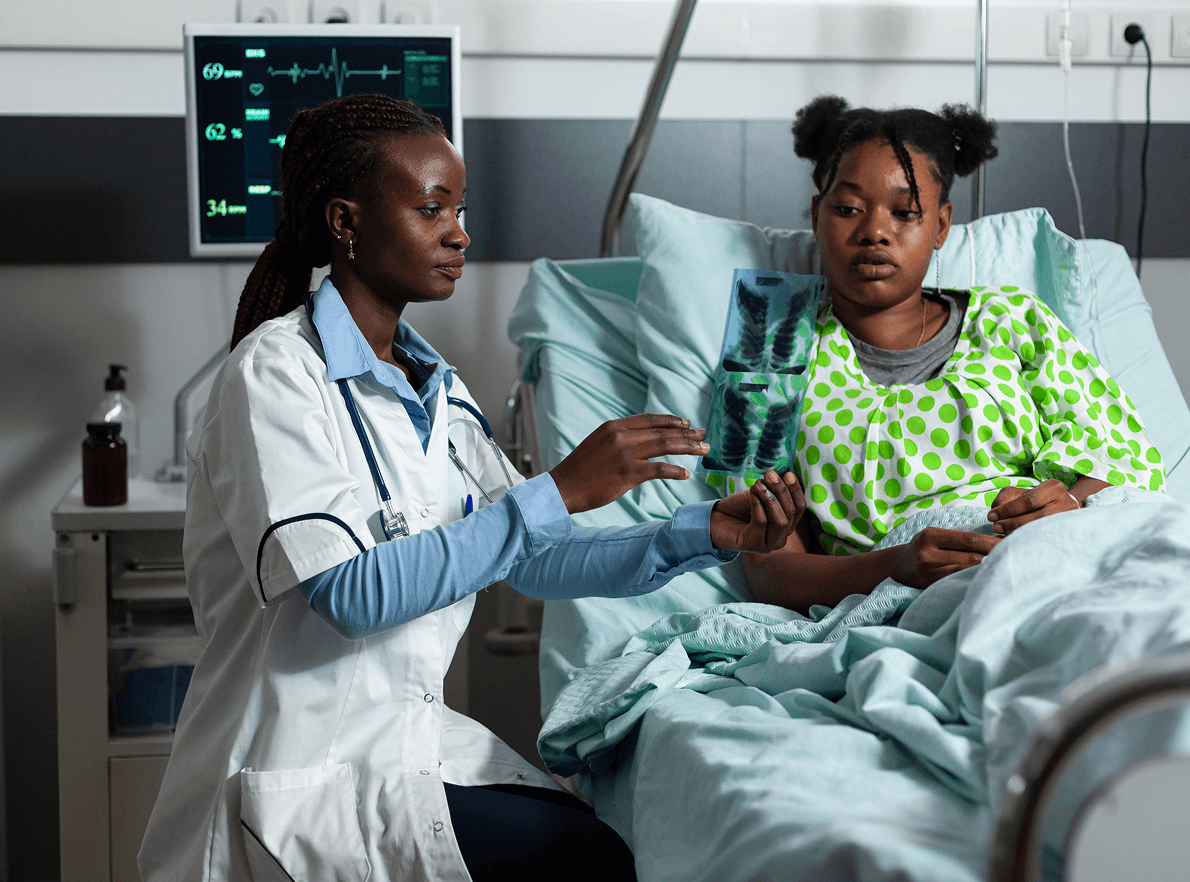 Doctor checking on a patient in hospital bed